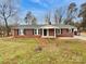 Charming brick home featuring a well-maintained lawn and traditional architectural details at 279 Timberland Loop, Mooresville, NC 28115