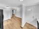 Bright living room with laminate flooring, neutral walls, and a chandelier creates a welcoming atmosphere at 279 Timberland Loop, Mooresville, NC 28115