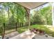 Covered back patio with black metal fencing and wooded views at 3052 Santee Ct, Indian Land, SC 29707