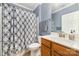 Bathroom with blue walls, vanity and sink, with patterned shower curtain is designed to create a calming retreat at 3052 Santee Ct, Indian Land, SC 29707