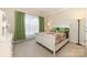 Cozy bedroom features a large window with bright light, neutral colored carpet, and an inviting comforter at 3052 Santee Ct, Indian Land, SC 29707