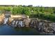 Aerial of Sun City Carolina Lakes entrance with waterfall feature and lush landscaping at 3052 Santee Ct, Indian Land, SC 29707