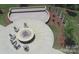 Aerial view of outdoor stone firepit with seating and manicured landscaping at 3052 Santee Ct, Indian Land, SC 29707