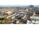 An aerial view of a modern townhome community with trees, streets, and city buildings at 3655 Vallette Ct, Charlotte, NC 28203