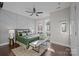 Bedroom featuring large windows, hardwood floors, bench, and a decorative geometric wall design at 3655 Vallette Ct, Charlotte, NC 28203