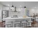 Open kitchen with island seating, stainless steel appliances, and modern white cabinetry, open to the living room at 3655 Vallette Ct, Charlotte, NC 28203