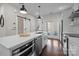 Stylish kitchen featuring stainless steel appliances, a central island, and sleek white cabinetry at 3655 Vallette Ct, Charlotte, NC 28203