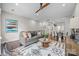 Open living room features hardwood floors, modern ceiling fan, and an artistic decorative rug at 3655 Vallette Ct, Charlotte, NC 28203