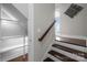 Staircase with hardwood steps, white risers, and modern railings leads to upper floors at 3655 Vallette Ct, Charlotte, NC 28203
