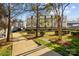 Townhomes with a sidewalk, bench and greenery in a well-maintained community at 3655 Vallette Ct, Charlotte, NC 28203