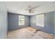 Spacious bedroom with two windows offering natural light and wood flooring needing repair at 405 Link St, Fort Mill, SC 29715