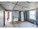 Bedroom with a ceiling tile, wood flooring, and trim needing repair at 405 Link St, Fort Mill, SC 29715