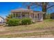Quaint, light grey home with a covered front porch and mature landscaping at 405 Link St, Fort Mill, SC 29715