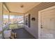 Covered front porch with grey siding, white railing, and room for seating at 405 Link St, Fort Mill, SC 29715