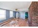 Living room features wood-look floors, brick accent wall, and ceiling fan at 405 Link St, Fort Mill, SC 29715