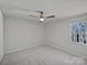 Minimalist bedroom offers a serene setting with soft carpet, fan, and natural light at 426 W Ballard St, Cherryville, NC 28021