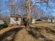 Charming home featuring a carport and inviting front porch with vibrant red shutters and door at 426 W Ballard St, Cherryville, NC 28021