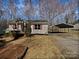 Charming home featuring a carport and inviting front porch with vibrant red shutters and door at 426 W Ballard St, Cherryville, NC 28021
