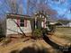 Charming home featuring a carport and inviting front porch with vibrant red shutters and door at 426 W Ballard St, Cherryville, NC 28021