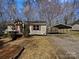 Charming one-story home with a gravel driveway, carport, and red window shutters at 426 W Ballard St, Cherryville, NC 28021