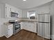 Well-lit kitchen with stainless steel appliances, ample cabinet space, and durable countertop at 426 W Ballard St, Cherryville, NC 28021