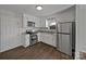 Modern kitchen with stainless steel appliances, white cabinets, and luxury vinyl plank flooring at 426 W Ballard St, Cherryville, NC 28021