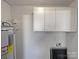 Laundry area with ample white cabinets, a water heater, and hookups at 426 W Ballard St, Cherryville, NC 28021