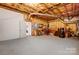 Unfinished basement with exposed ceiling insulation and carpeted flooring at 4633 River Bluff Ct, Charlotte, NC 28214