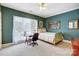 Comfortable bedroom featuring neutral carpet, teal walls, a ceiling fan and an expansive window at 4633 River Bluff Ct, Charlotte, NC 28214