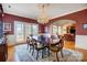 Elegant dining room with a chandelier, arched doorway, and access to the deck at 4633 River Bluff Ct, Charlotte, NC 28214