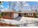 Charming brick home featuring an attached garage and a circular driveway with neatly trimmed landscaping at 4633 River Bluff Ct, Charlotte, NC 28214