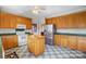 Well-lit kitchen featuring wood cabinets, stainless steel refrigerator, and a unique checkered floor at 4633 River Bluff Ct, Charlotte, NC 28214