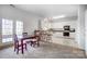 Bright open floor plan with kitchen featuring white cabinets, modern appliances, and dining area at 4633 River Bluff Ct, Charlotte, NC 28214