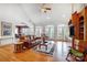 Open concept living room featuring large windows, hardwood floors, and comfortable seating at 4633 River Bluff Ct, Charlotte, NC 28214