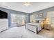 Cozy main bedroom with a queen bed, a walk-out to the deck, and natural light at 4633 River Bluff Ct, Charlotte, NC 28214