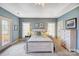 Relaxing main bedroom with a queen bed, soft blue walls, carpet, and natural light at 4633 River Bluff Ct, Charlotte, NC 28214