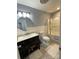 Bathroom with tub-shower, single sink vanity with a stylish round mirror at 5434 Beckhaven Ln, Charlotte, NC 28216