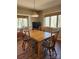 Inviting dining room with a wooden table, seating for six, and large windows overlooking the backyard at 5434 Beckhaven Ln, Charlotte, NC 28216