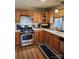 Bright kitchen featuring stainless steel appliances, light wood cabinets and wood-look floors at 5434 Beckhaven Ln, Charlotte, NC 28216