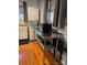 Functional laundry room featuring a stackable washer and dryer and metal work table at 5434 Beckhaven Ln, Charlotte, NC 28216
