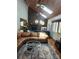 Sunlit living room boasting a brick fireplace, skylights, hardwood floors, and modern furnishings at 5434 Beckhaven Ln, Charlotte, NC 28216