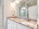 Bathroom featuring a granite-topped double sink vanity and a large mirror at 6000 Embassy Ct, Wesley Chapel, NC 28110