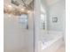 Bright bathroom featuring a glass shower and a luxurious soaking tub with a window at 6000 Embassy Ct, Wesley Chapel, NC 28110