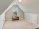 Bonus room featuring neutral carpeting and an attic window at 6000 Embassy Ct, Wesley Chapel, NC 28110