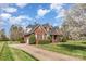 Charming brick home featuring a well-manicured lawn and mature landscaping at 6000 Embassy Ct, Wesley Chapel, NC 28110