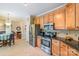 Kitchen with stainless steel appliances, granite counters, and tile flooring at 6000 Embassy Ct, Wesley Chapel, NC 28110
