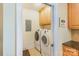 Laundry room with washer, dryer, and storage cabinets at 6000 Embassy Ct, Wesley Chapel, NC 28110