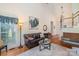 Bright living room boasts hardwood floors and ample seating with a large window at 6000 Embassy Ct, Wesley Chapel, NC 28110