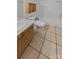 Bright bathroom features wood cabinets, tile flooring, and a bathtub with shower at 670 Sherwood Pl, Mooresville, NC 28115