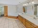 Large bathroom featuring a soaking tub, double vanity, and a window for natural light at 670 Sherwood Pl, Mooresville, NC 28115
